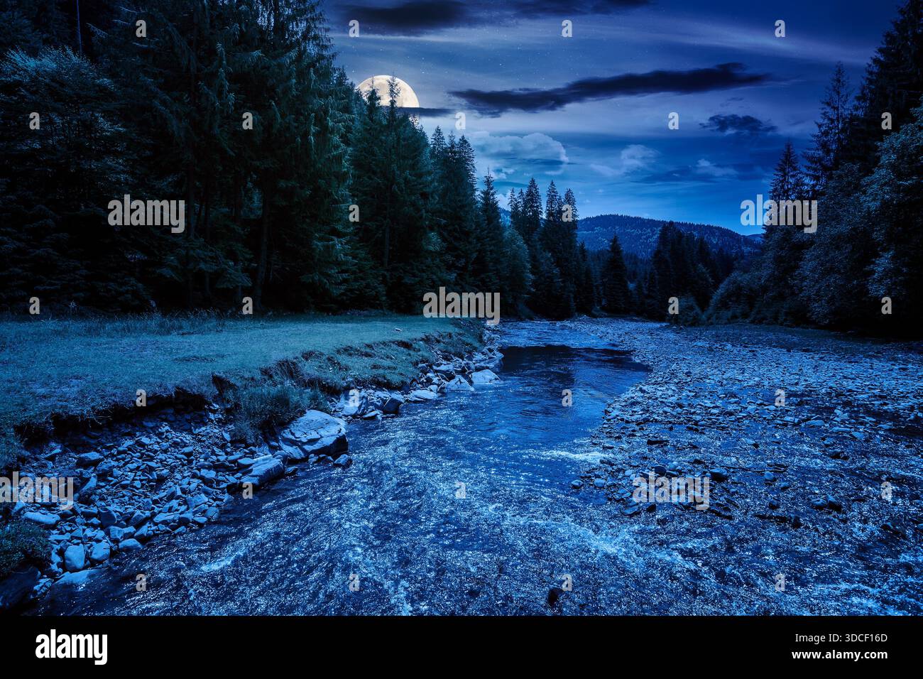 landscape with mountains, forest and a river in front at night. beautiful scenery in summer in full moon light. water flowing through park. nature bac Stock Photo
