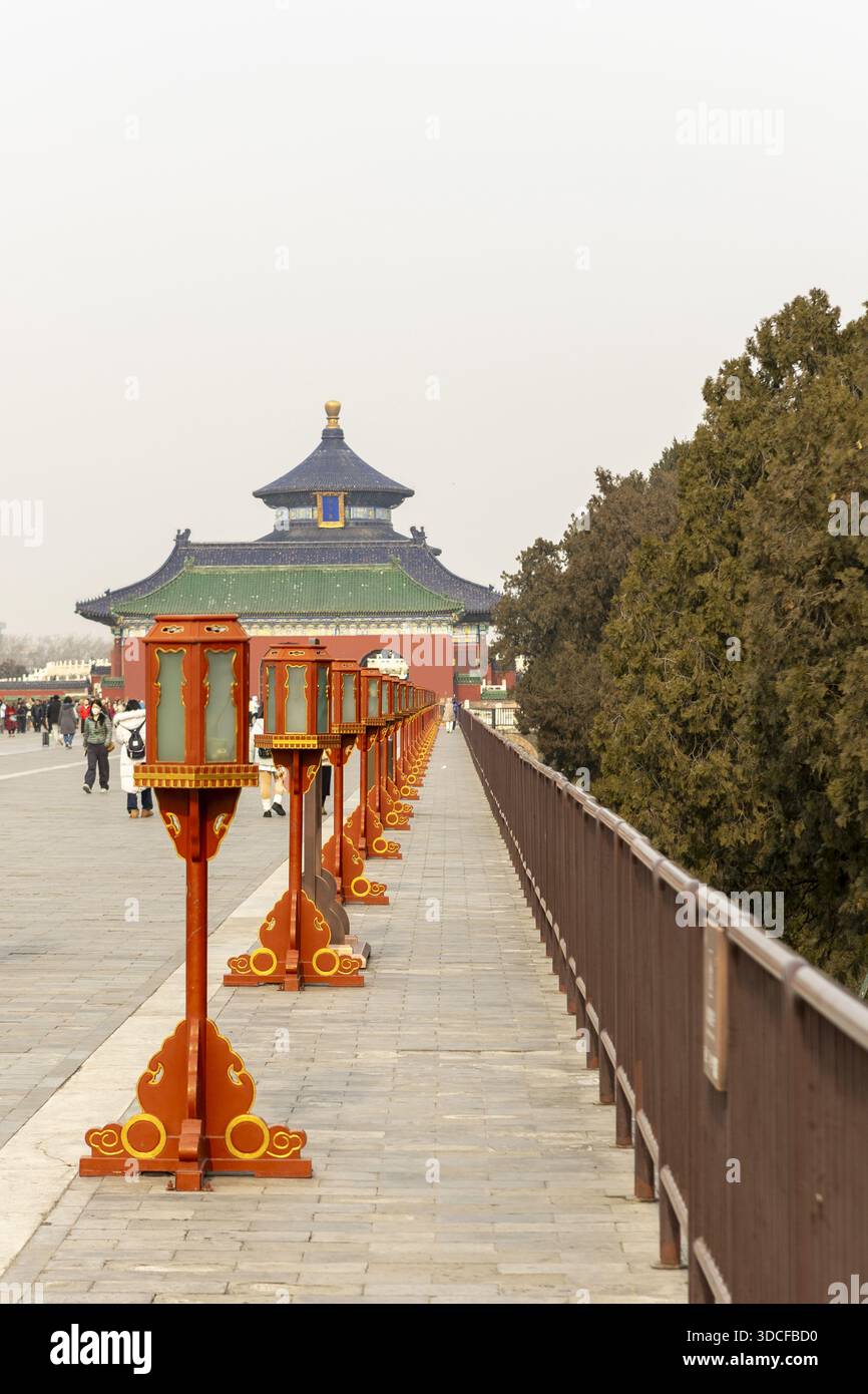 View of the Temple of Heaven's Hall of Prayer for Good Harvests framed by traditional orange lanterns and weathered stone, Beijing, Beijing, China. Stock Photo
