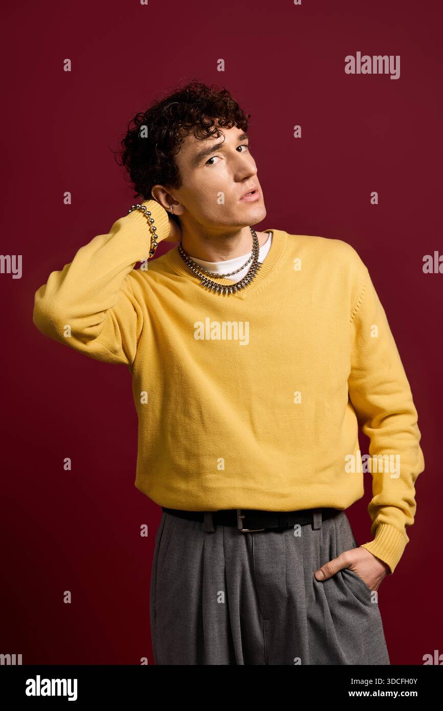 Handsome man exudes charm in stylish attire, striking a pose with ...