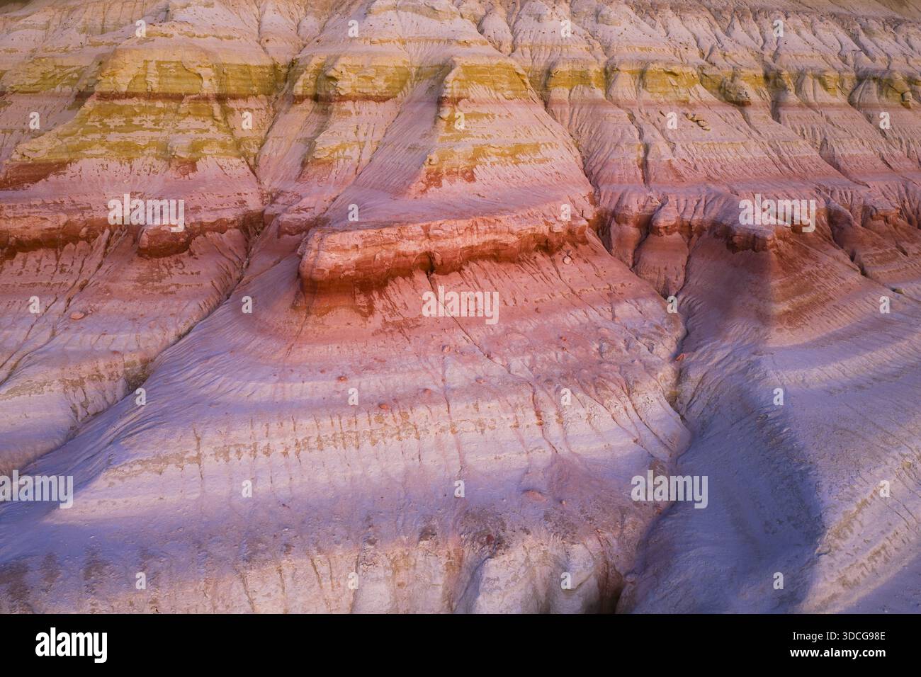 Aerial view of layered sedimentary rock formations displaying a ...