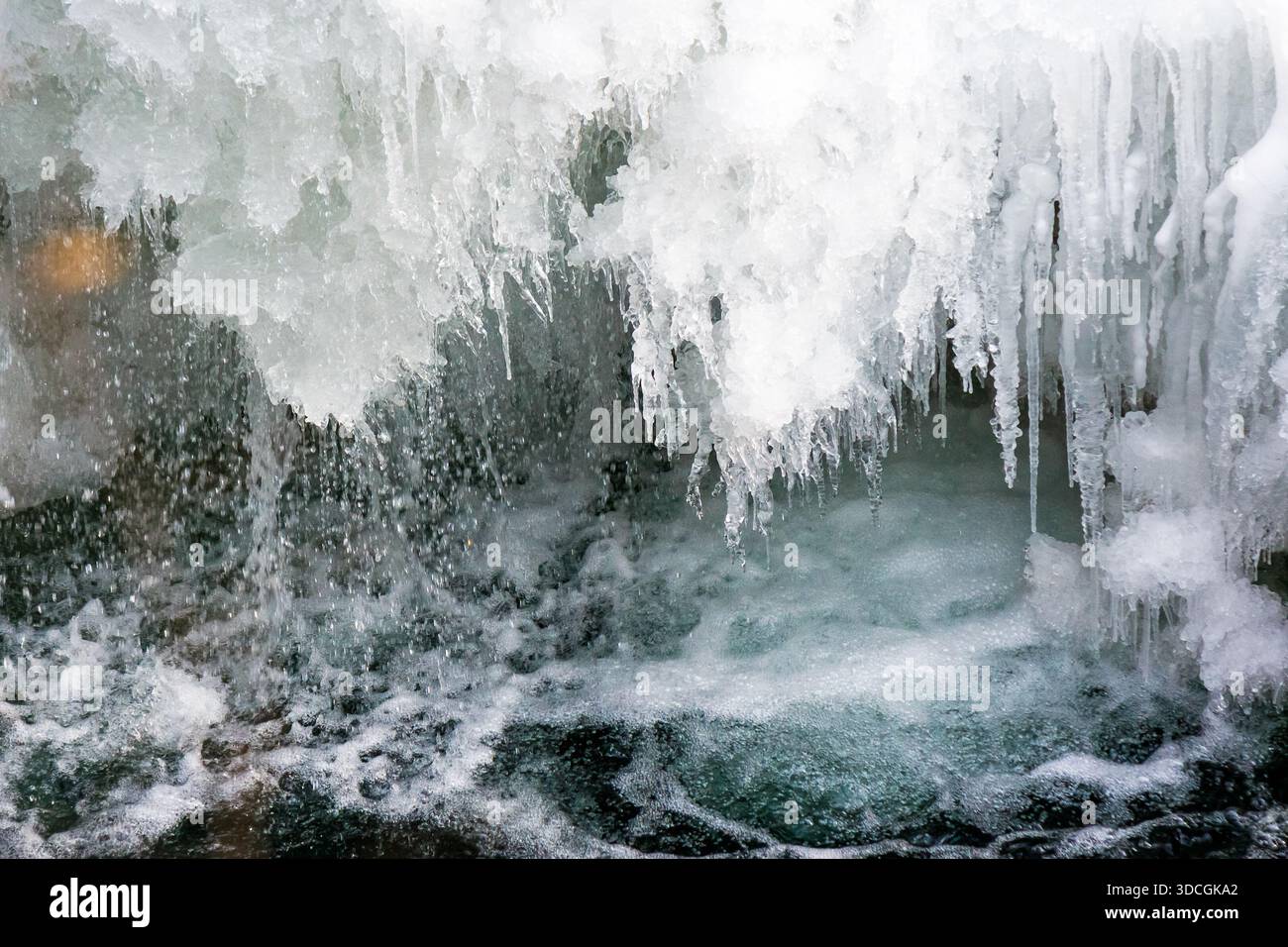frozen waterfall close up view. icicles hanging above water. cold winter landscape photography on river tyrychka of transcarpathia ukraine. seasonal n Stock Photo
