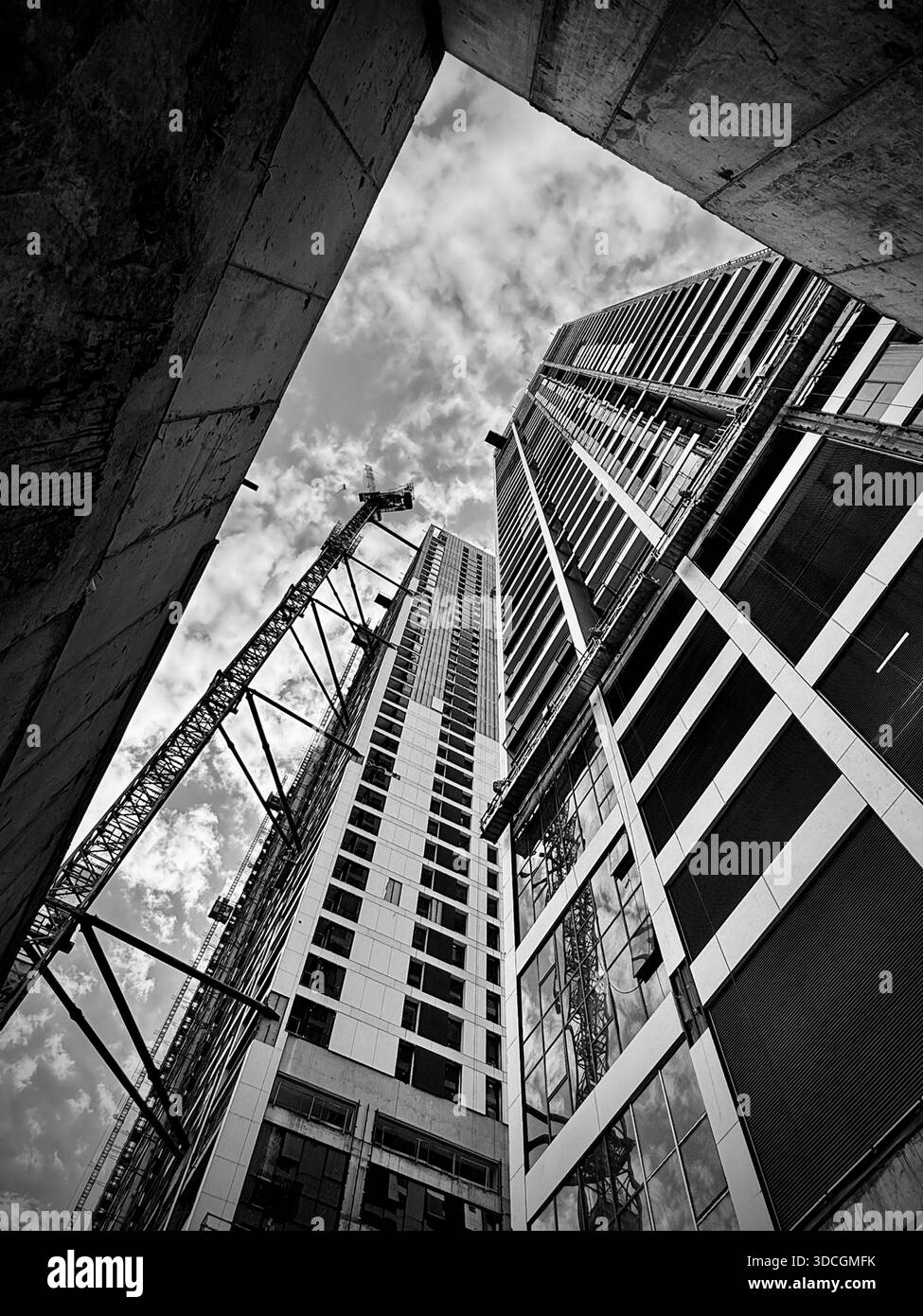 Rising lines of steel and concrete converge toward the sky, capturing the power and ambition of modern urban architecture. - Smartphone Captured Stock Image