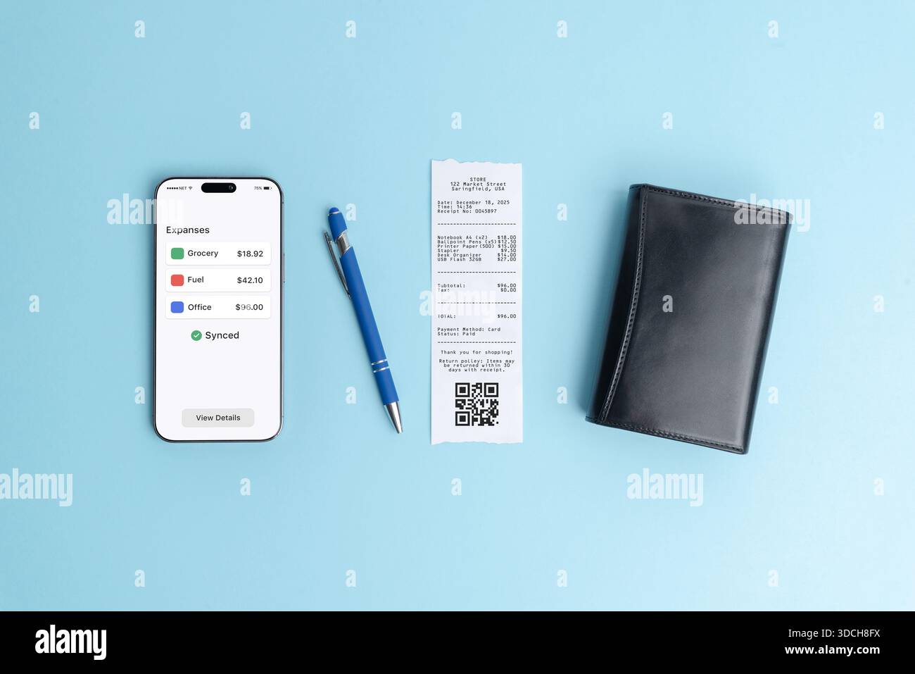 Smartphone displaying expenses overview dashboard next to paper receipt on blue background, illustrating modern finance app, bookkeeping software, bus Stock Photo