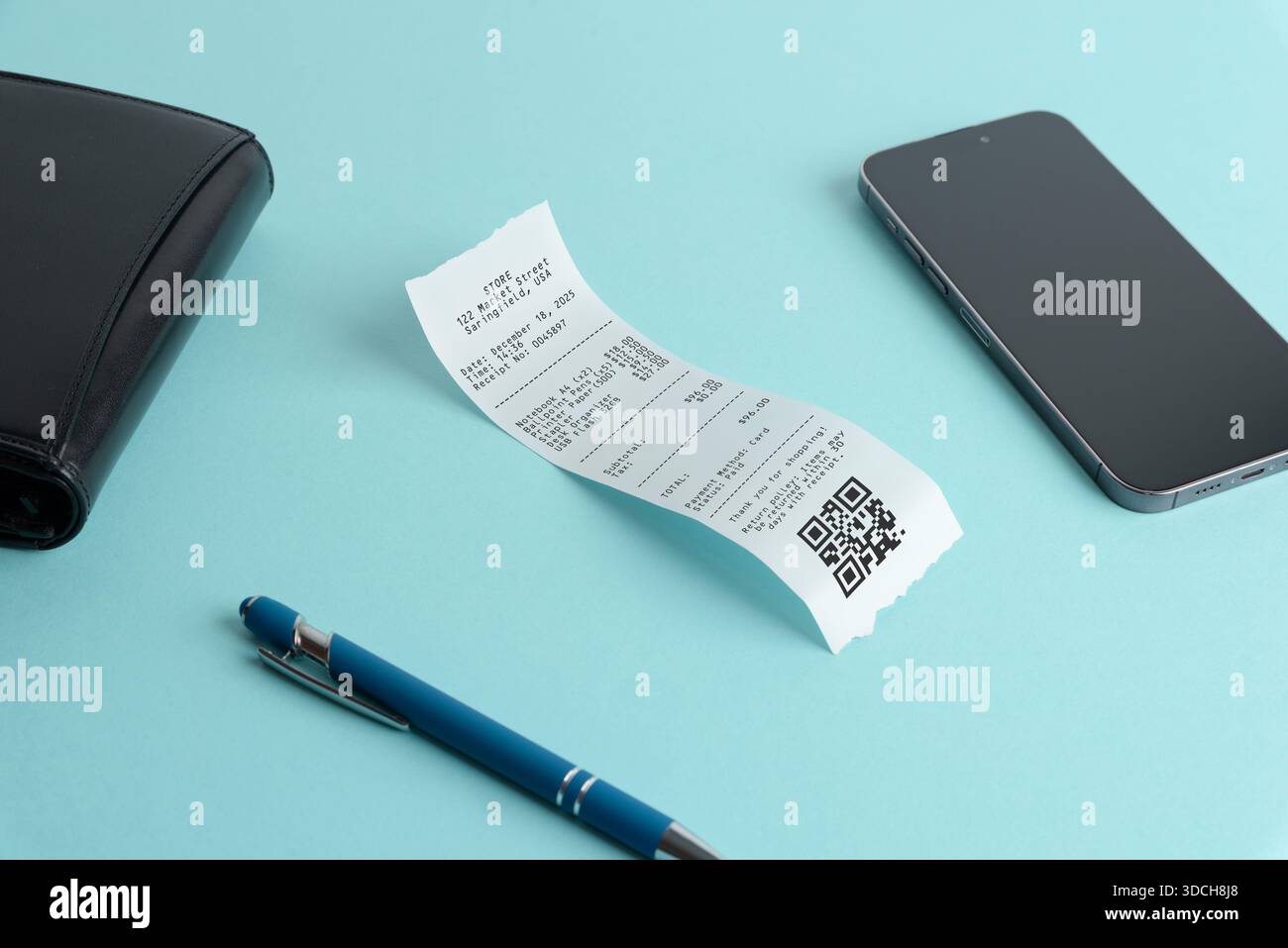 Modern expense tracking concept with smartphone, wallet, pen and paper receipt on blue background, representing digital finance, bookkeeping, payments Stock Photo