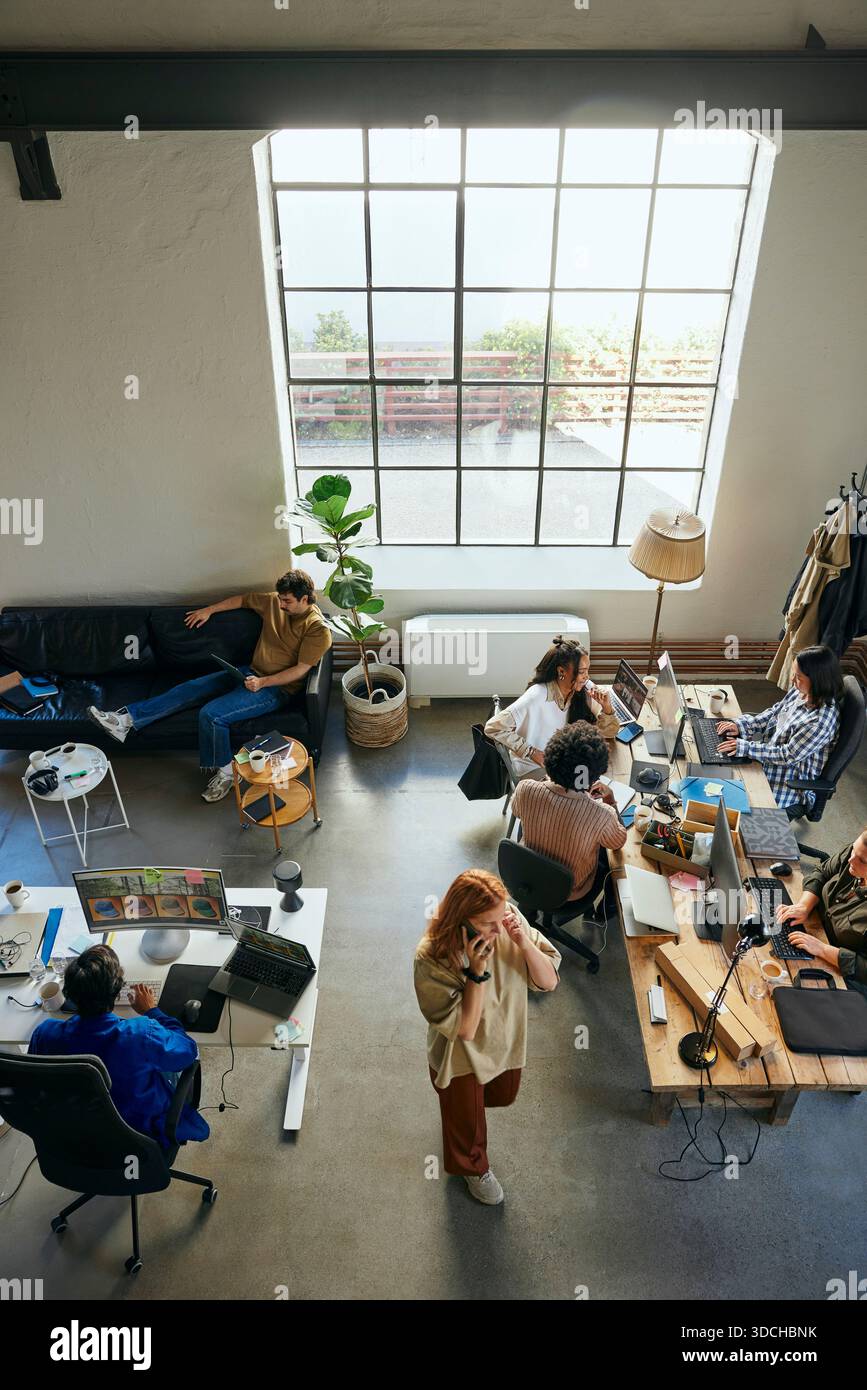 High angle view of multiracial programmers group working in new tech office Stock Photo