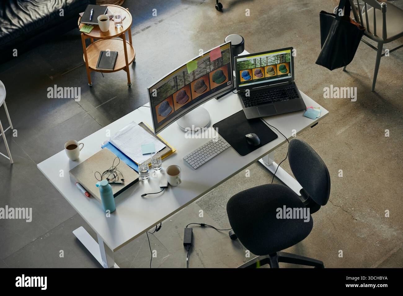 High angle view of images seen on computers at desk in startup tech office Stock Photo