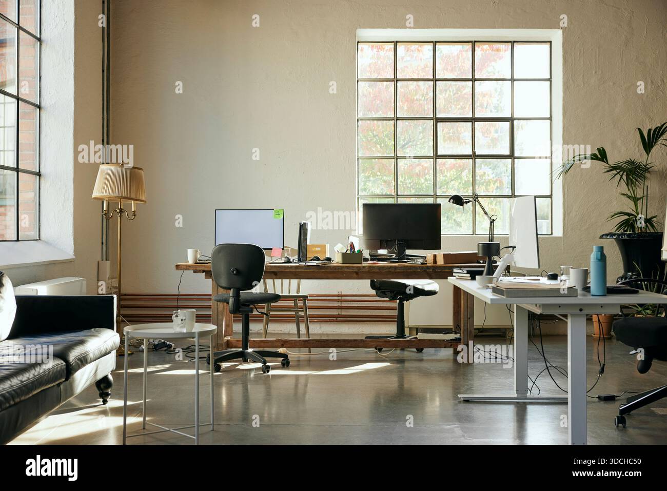 Computers kept on desk in new tech hub Stock Photo