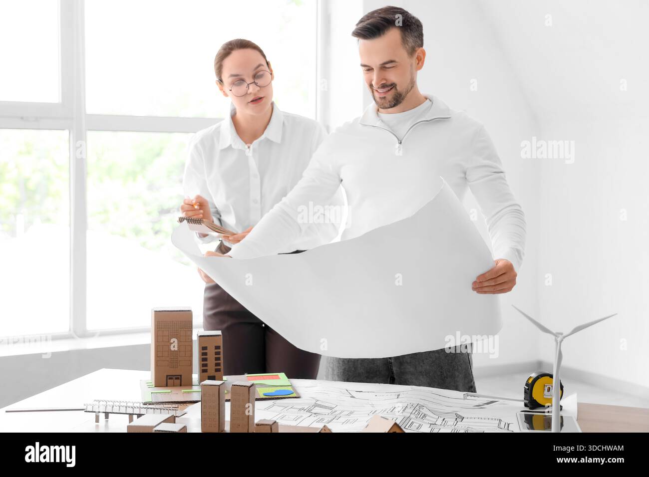 Young architects working with house plan in office Stock Photo