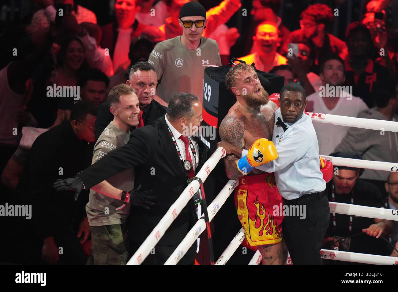Jake Paul, left, is held against the ropes after his heavyweight boxing ...