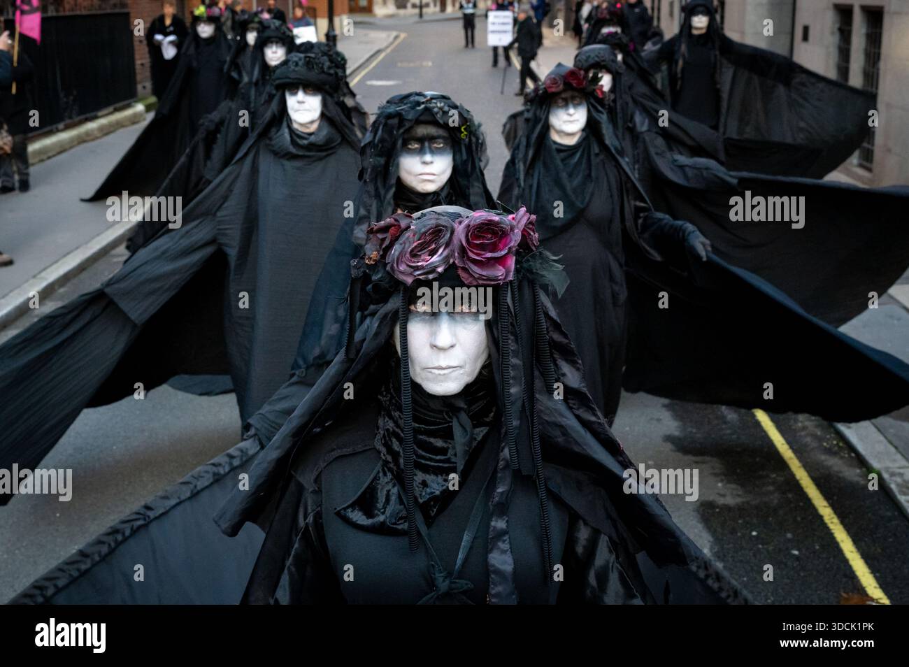 Oil Slickers seen posing during the protest. Extinction Rebellion Oil ...