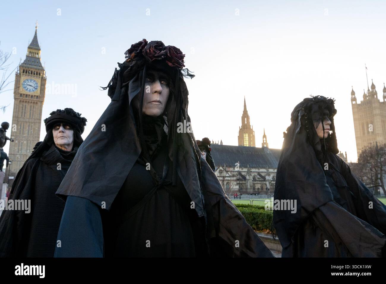 Oil Slickers seen walking past Parliament. Extinction Rebellion Oil ...