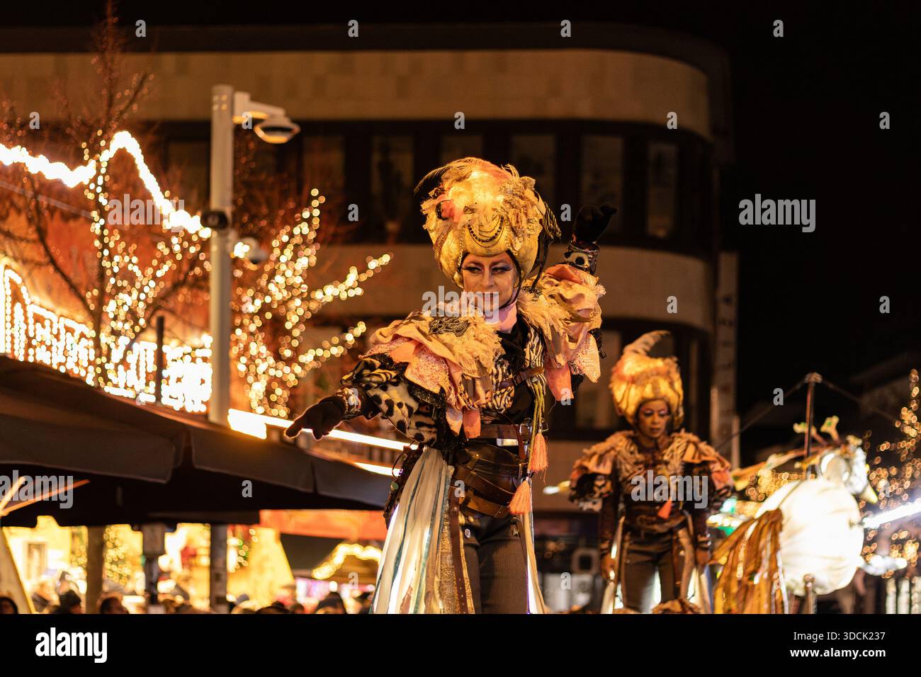 AALST, BELGIUM, 5 DECEMBER 2025: Costumed stilt walkers dance in the street parade at the Christmas festival of Aalst Twinkles. The evening marks the - Stock Image