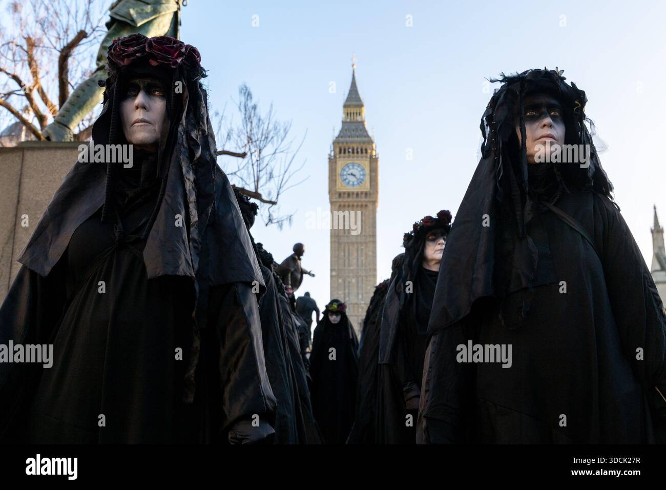 Oil Slickers seen walking past Parliament. Extinction Rebellion Oil ...
