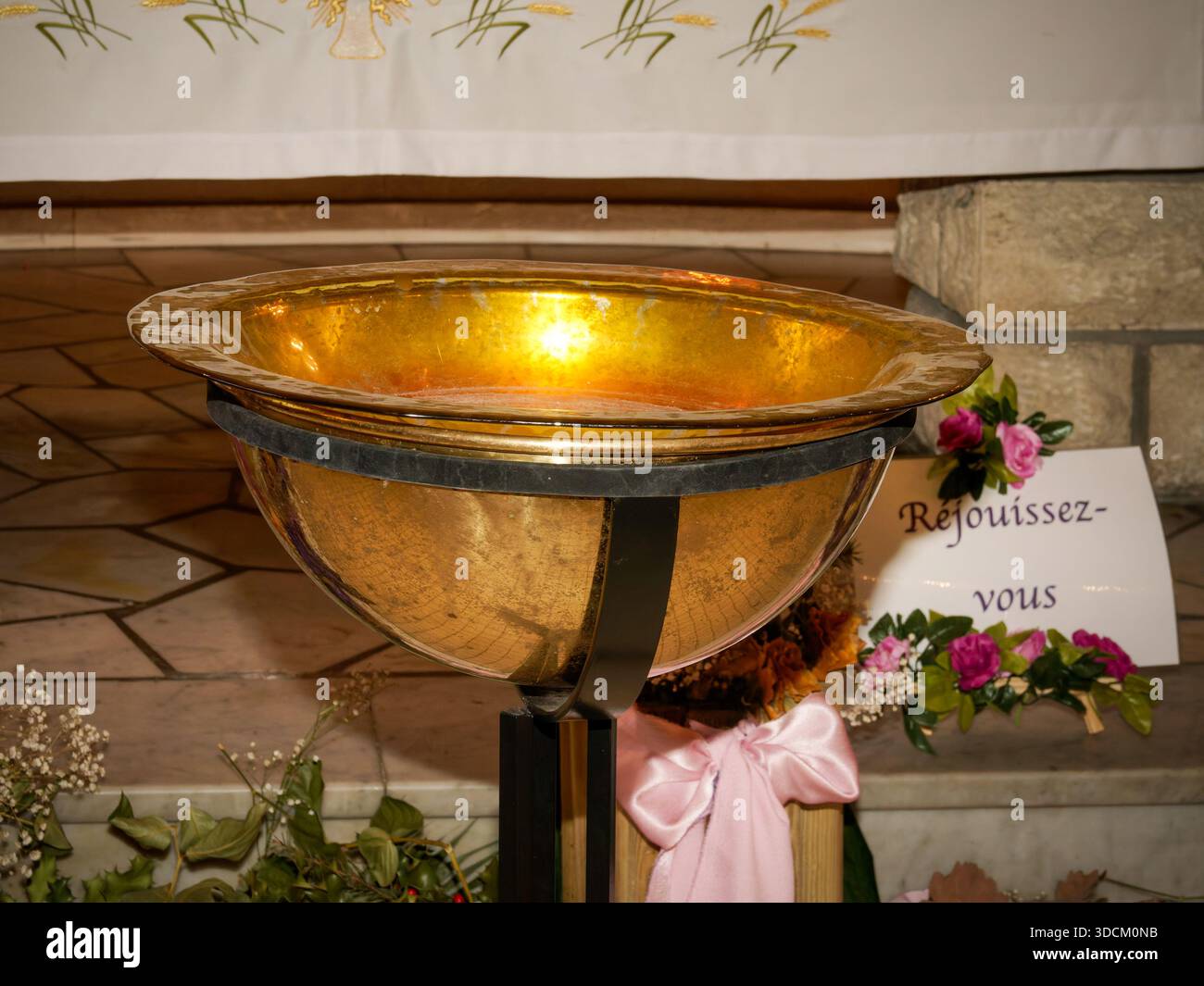 Golden baptismal font inside a church, used for Christian baptism ...