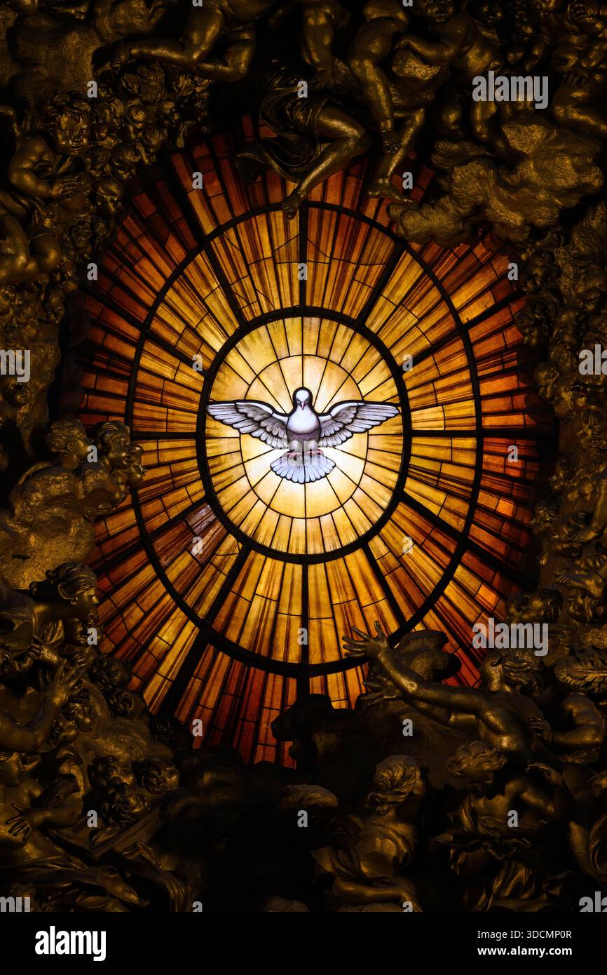 Central stained-glass window depicting the Holy Spirit in St Peter’s Basilica, Vatican, Rome, Italy. - Stock Image