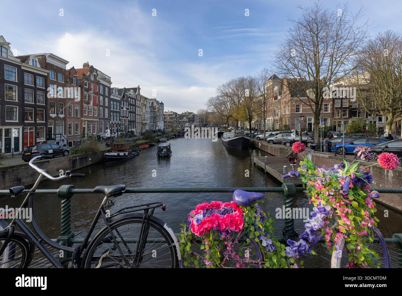 Amsterdam, Netherlands. Bikes on the bridge channel of Amsterdam city. Typical amsterdam transport, bicycles streets. Picturesque urban street vew in Stock Photo
