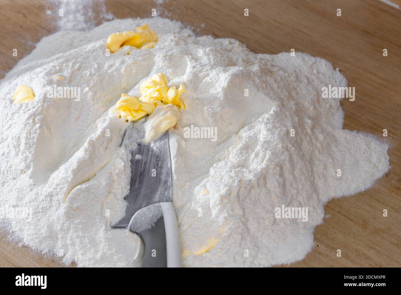 Kneading traditional dough for meat dumplings for Christmas, making dough with flour, eggs, and butter, in the kitchen, realistic photos Stock Photo