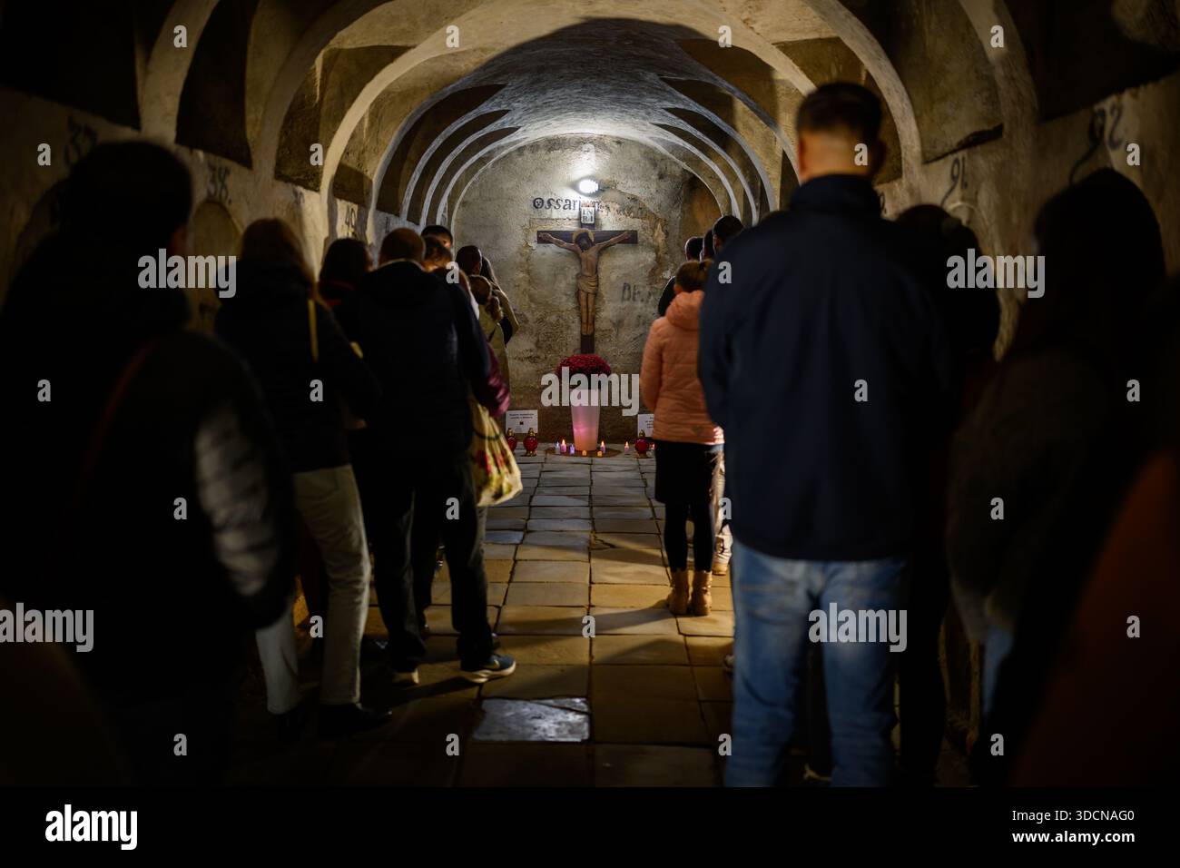 People pray in the crypt of the Seminary Church of St Anthony of Padua in Košice, Slovakia during the Octave of All Souls’ Day. - Stock Image
