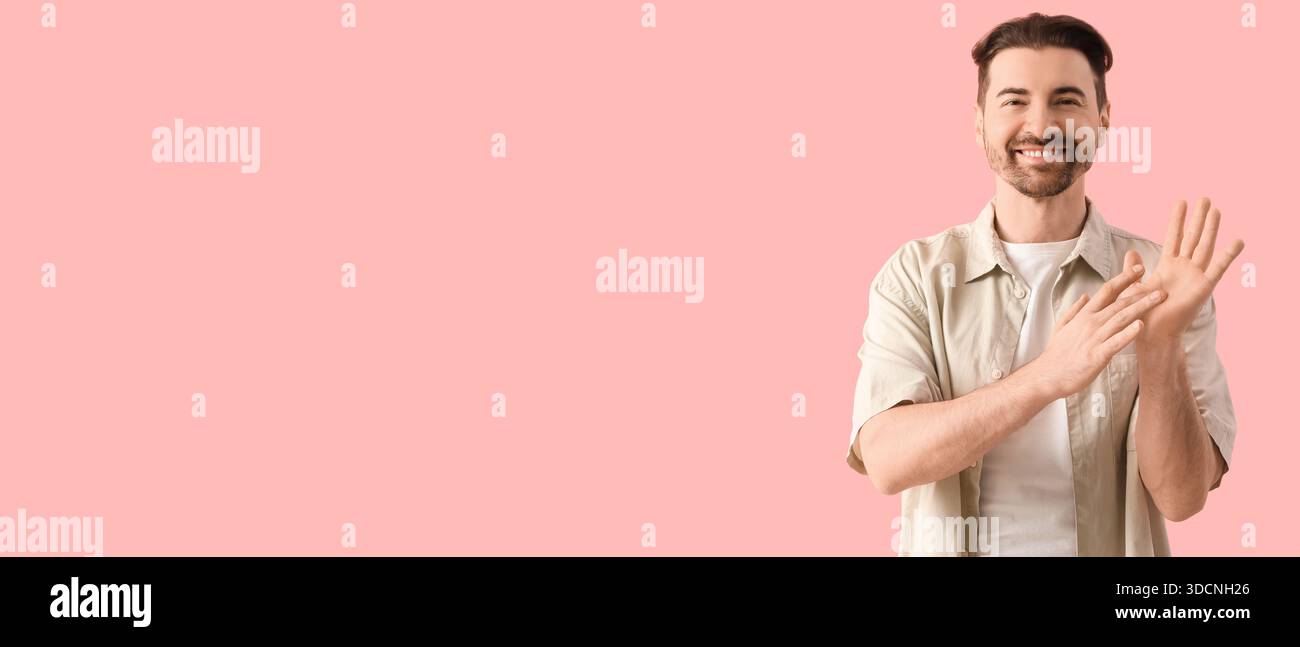 Man using sign language on pink background with space for text Stock Photo
