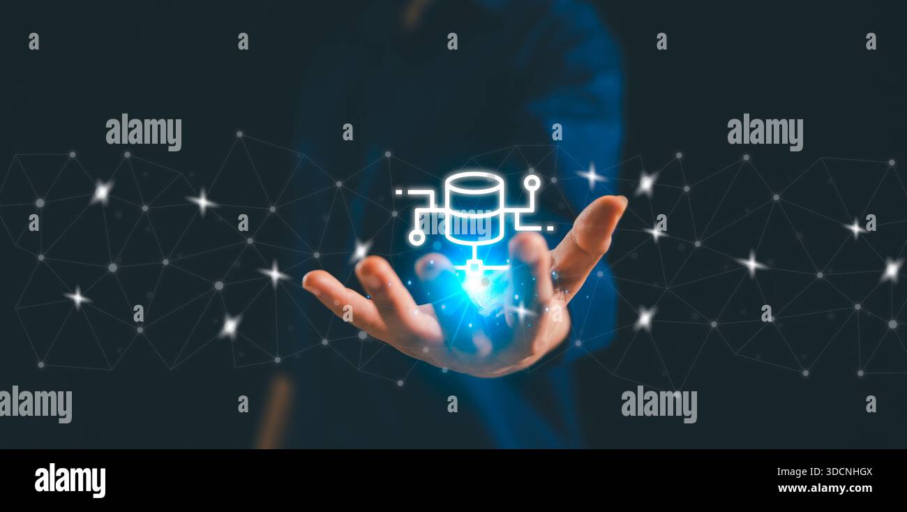 Business professional presenting a glowing database icon within a connected digital network, symbolizing data integration, cloud technology, cybersecu Stock Photo