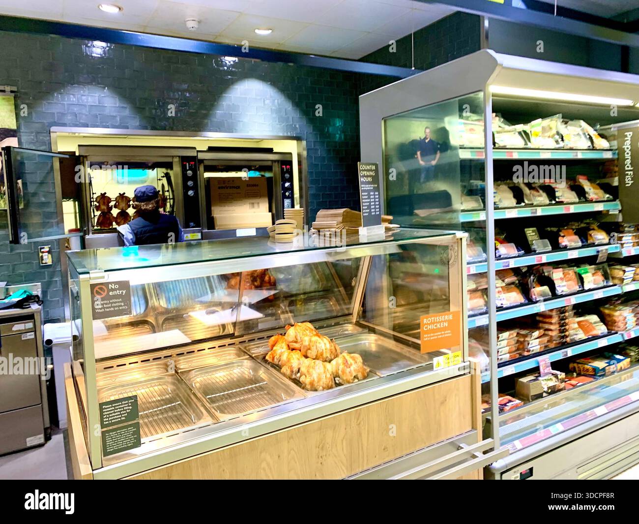 modern supermarket with automated retail technology fish counter and people shopping food counter exotic types in cabinet with staff serving - Smartphone Captured Stock Image