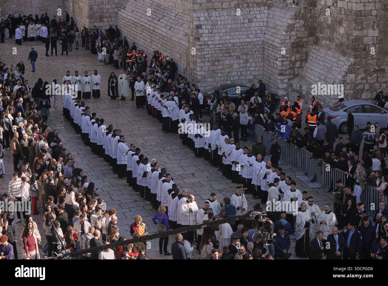 Catholic clergy walk in procession next to the Church of the Nativity ...