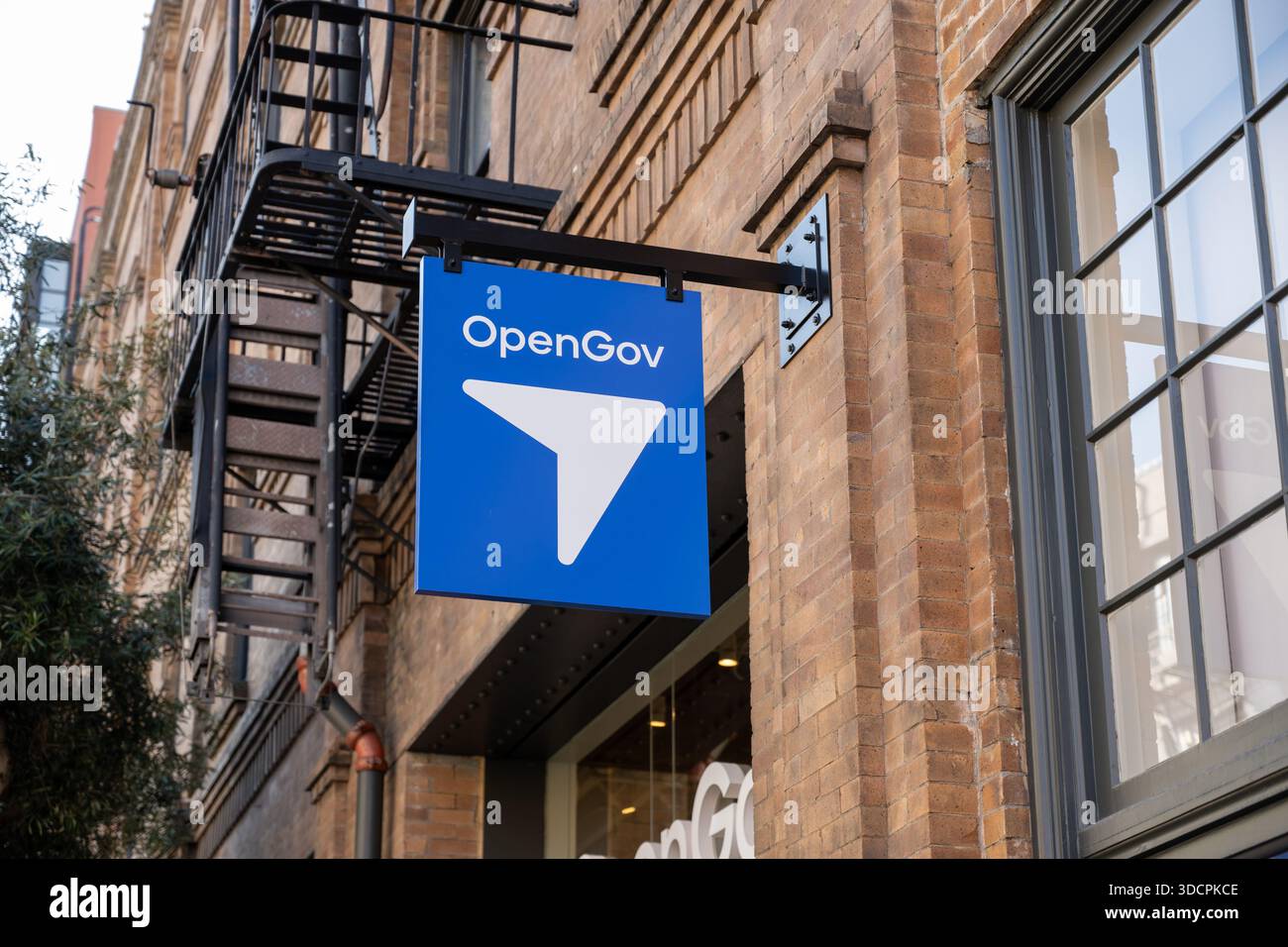 Government Open Sign OpenGov office sign hanging on historic brick building exterior in ...