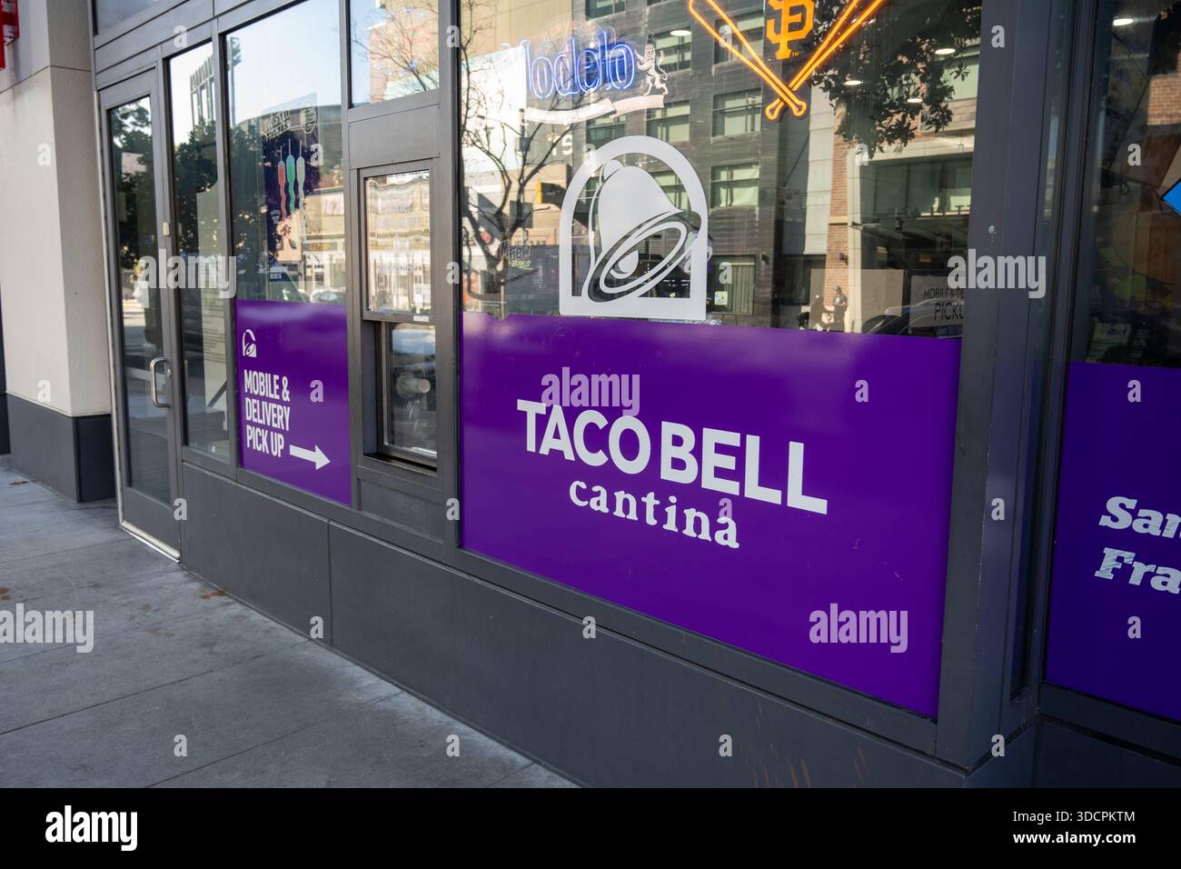 Storefront of Taco Bell Cantina with mobile and delivery pickup signage ...