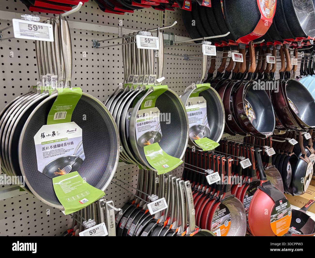 Zhang Xiao Quan non-stick woks. Skillet, cookware. Displayed on retail shelves in a Chinese supermarket, showcasing household kitchenware variety. Stock Photo