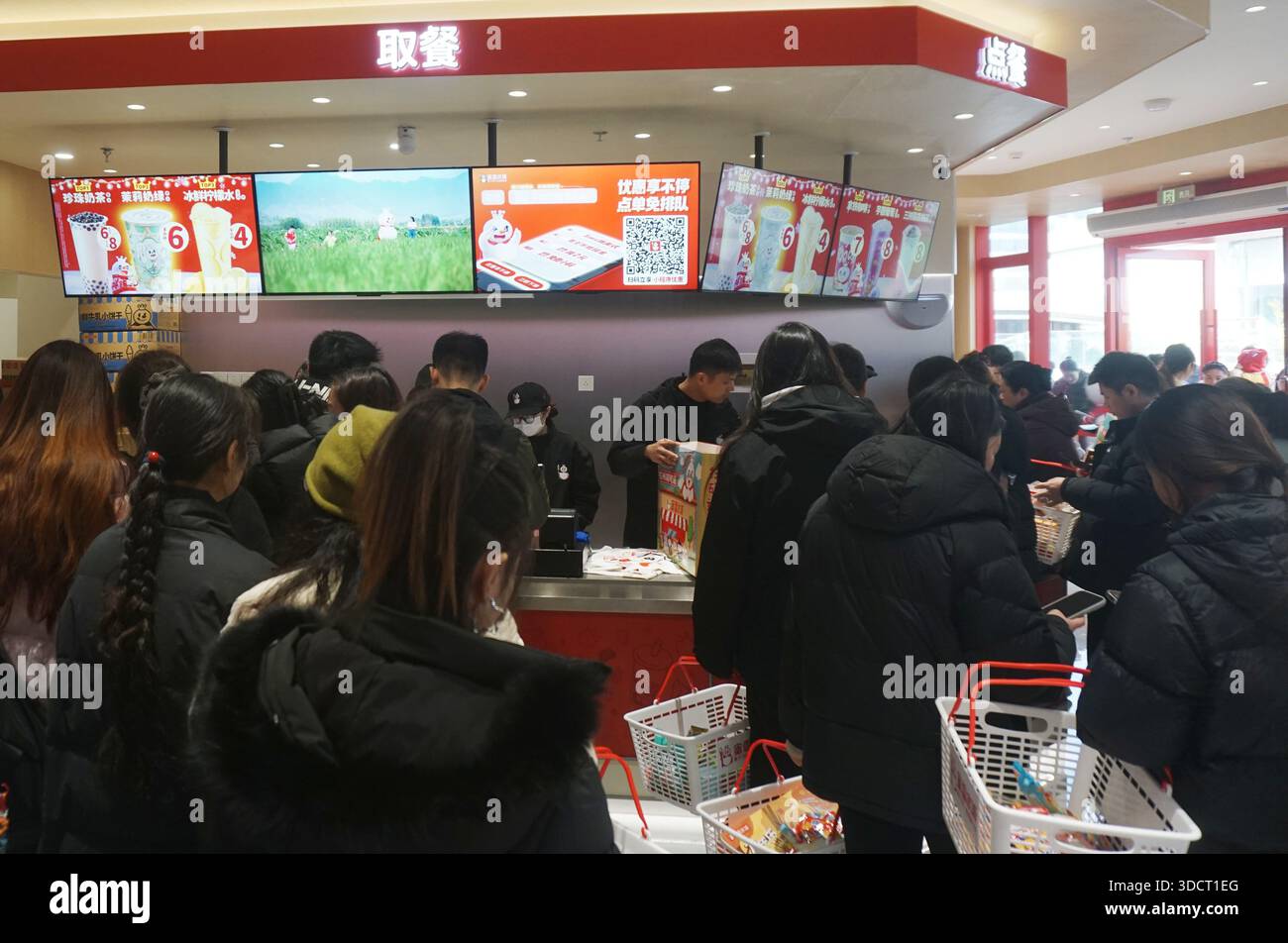 HANGZHOU, CHINA - DECEMBER 25, 2025 - Customers queue up to shop at ...