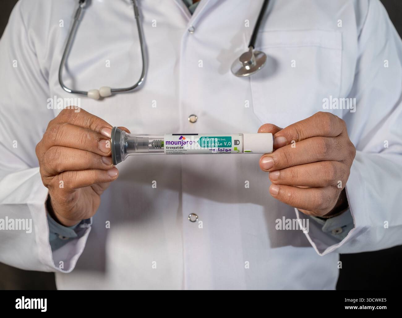 Medical doctor giving a thumbs up to successful Mounjaro tirzepatide weight  loss injection pen therapy Stock Photo - Alamy