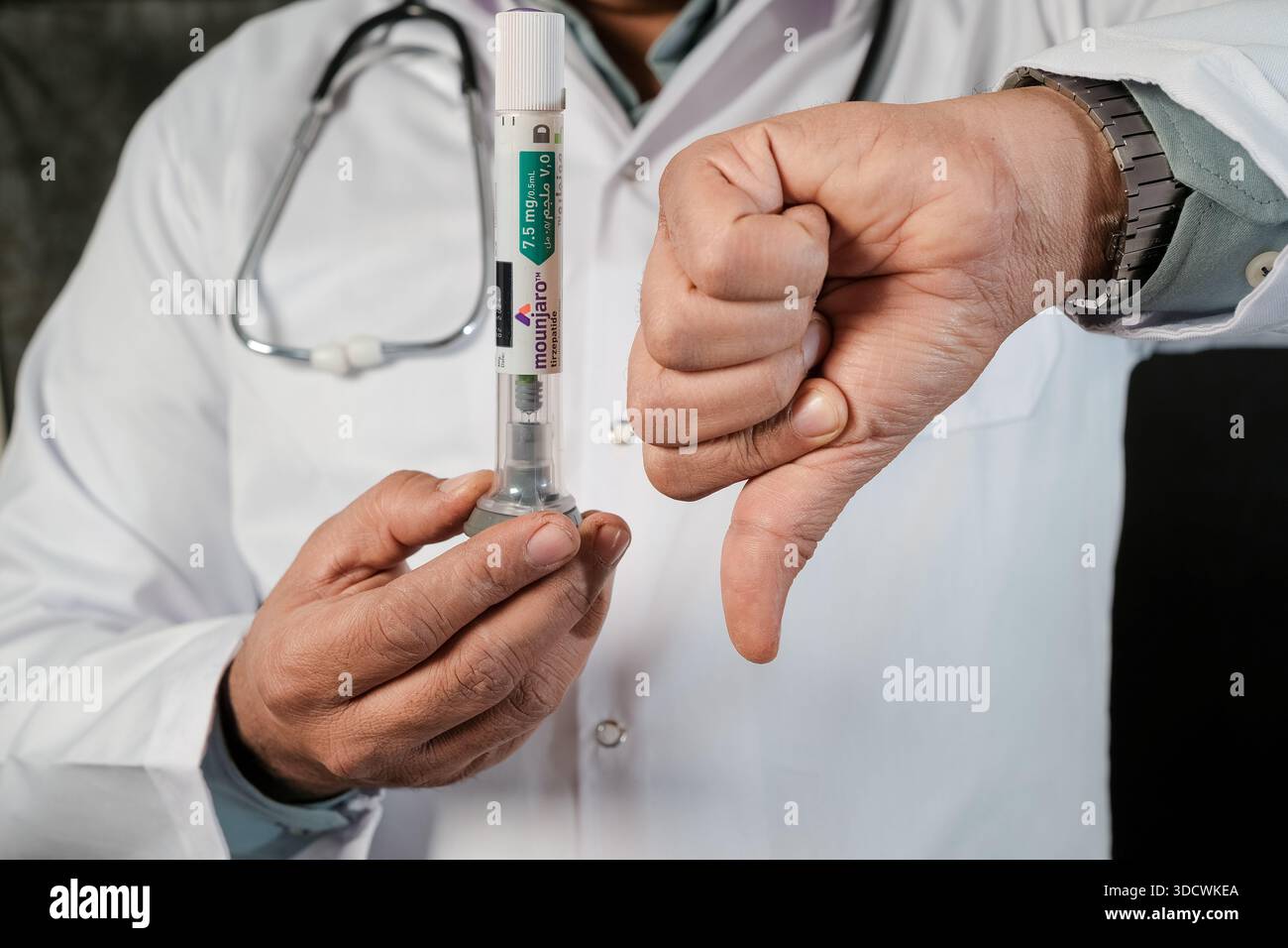 giving tirzepatide injection Healthcare professional giving a thumbs down to improper use of Mounjaro  tirzepatide weight loss injection pen Stock Photo