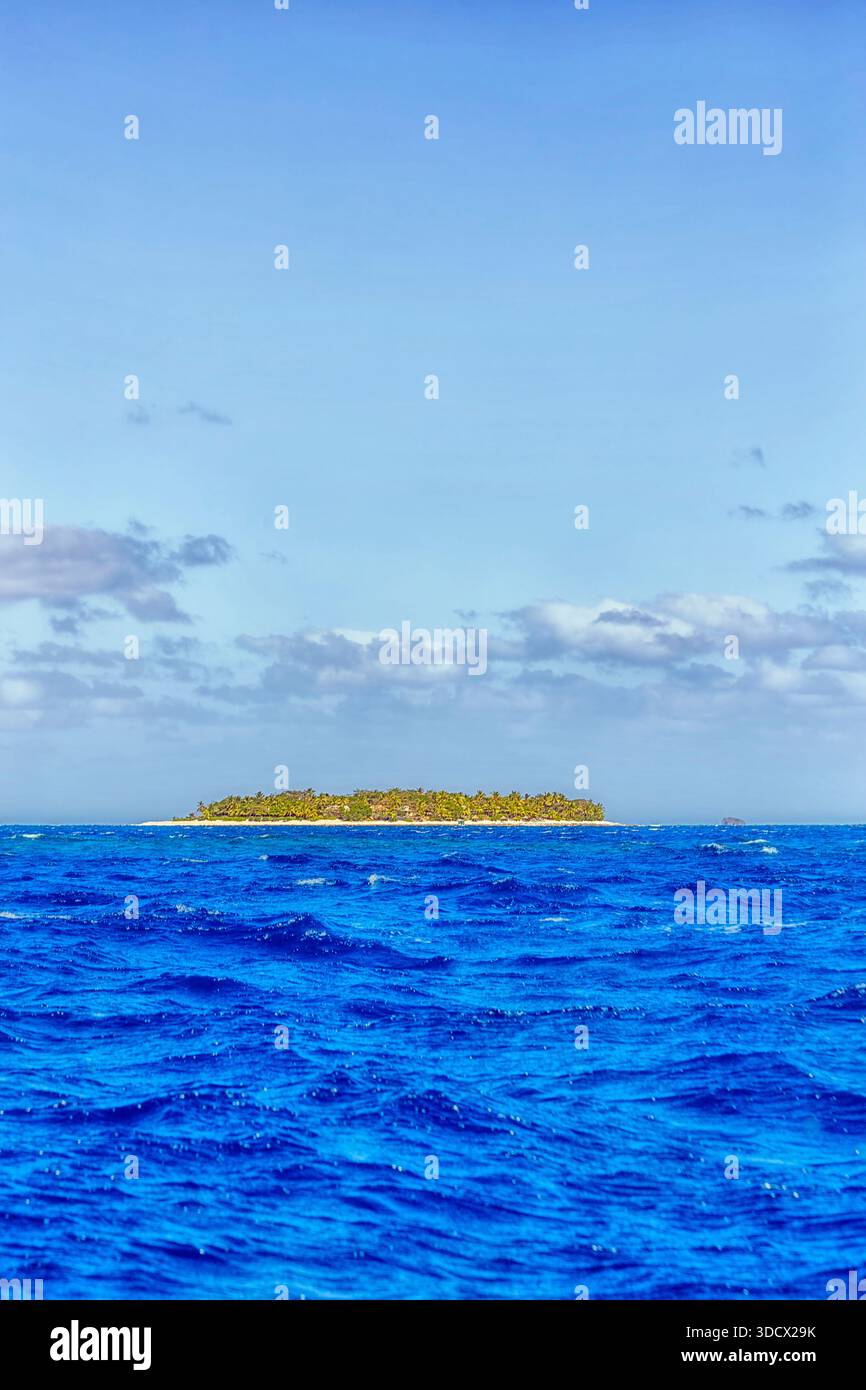 Fiji tropical tourism destination islands in Pacific Nadi to Mamanuca islands boat travel - palm island bright blue vert. Stock Photo