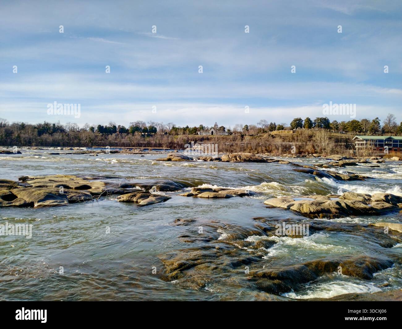 Powerful river current flowing over large smooth rocks Stock Photo