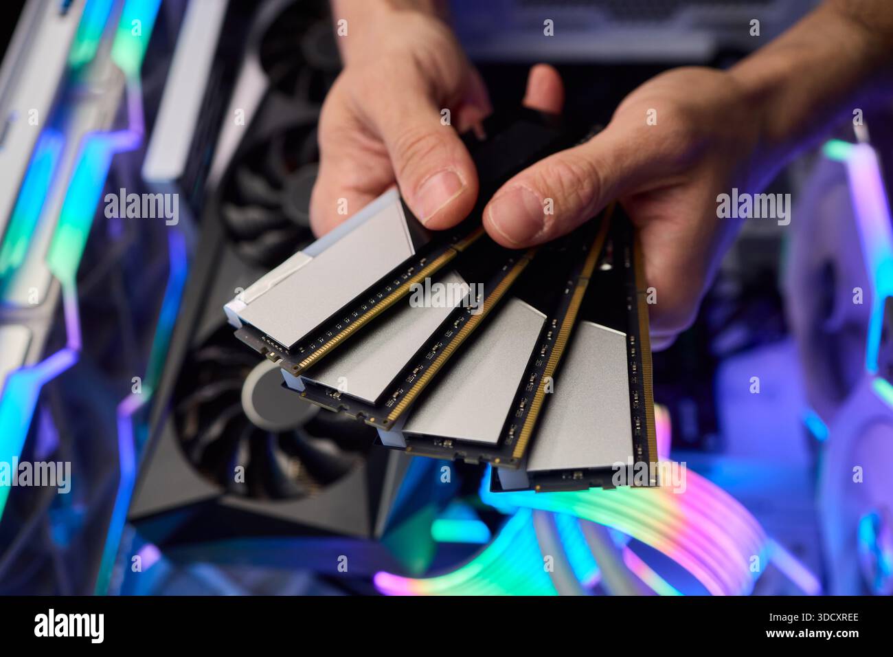 Computer hardware setup highlighting RAM sticks and graphics card details, Credentials for professional technical environment featuring RAM modules Stock Photo