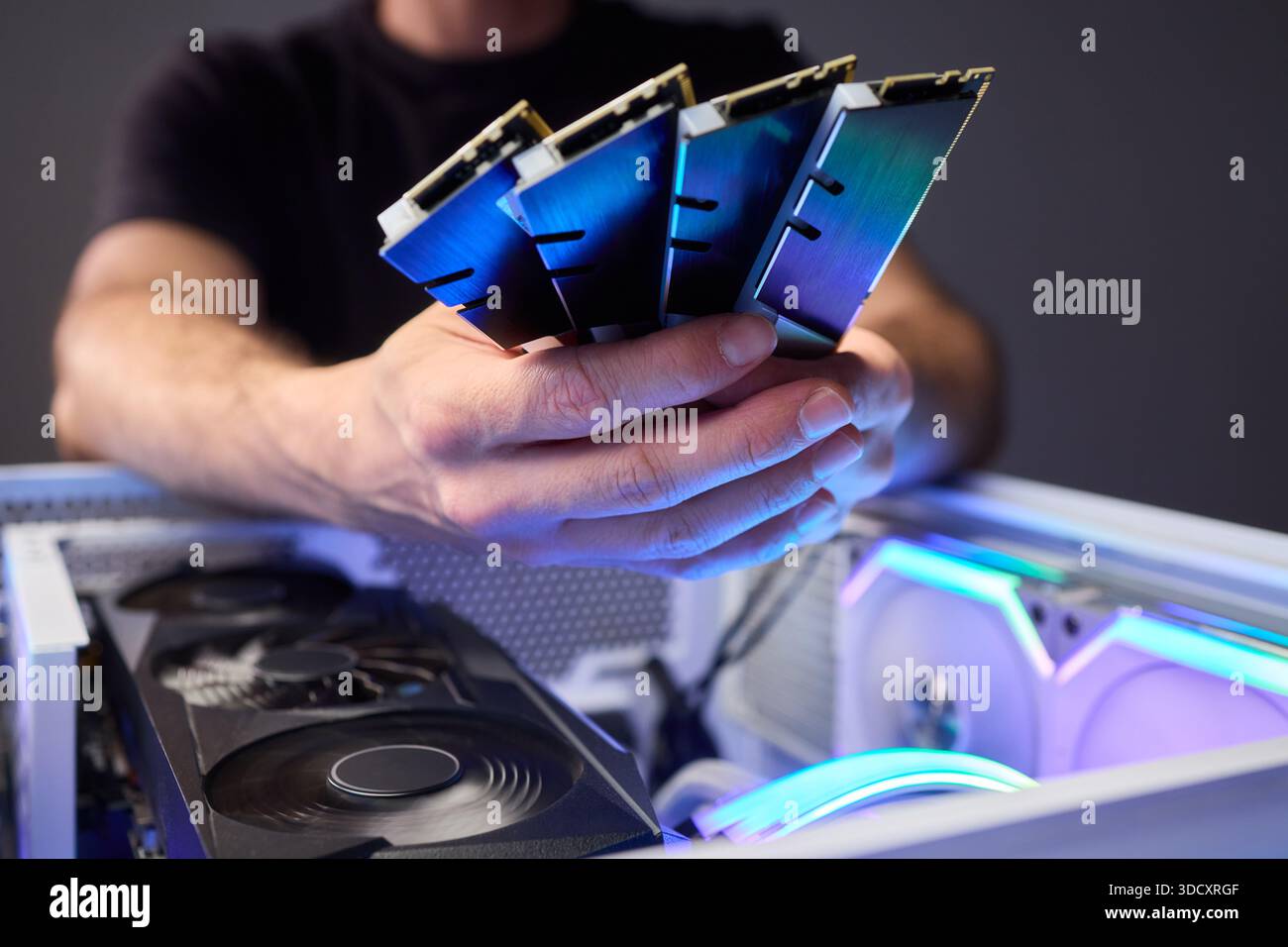 Computer hardware setup highlighting RAM sticks and graphics card details, Credentials for professional technical environment featuring RAM modules Stock Photo