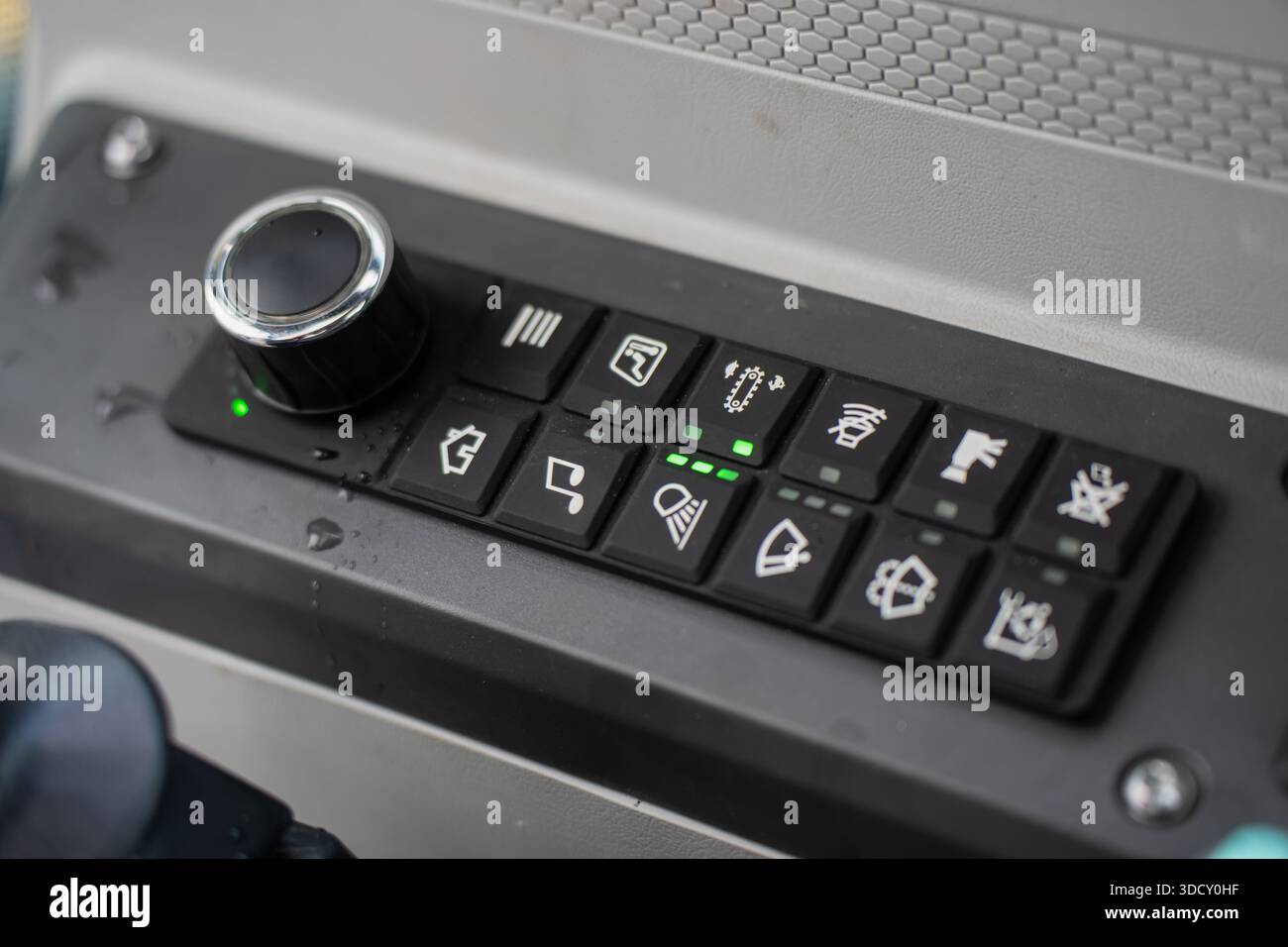 Heavy equipment operator control panel with labeled buttons, rotary ...