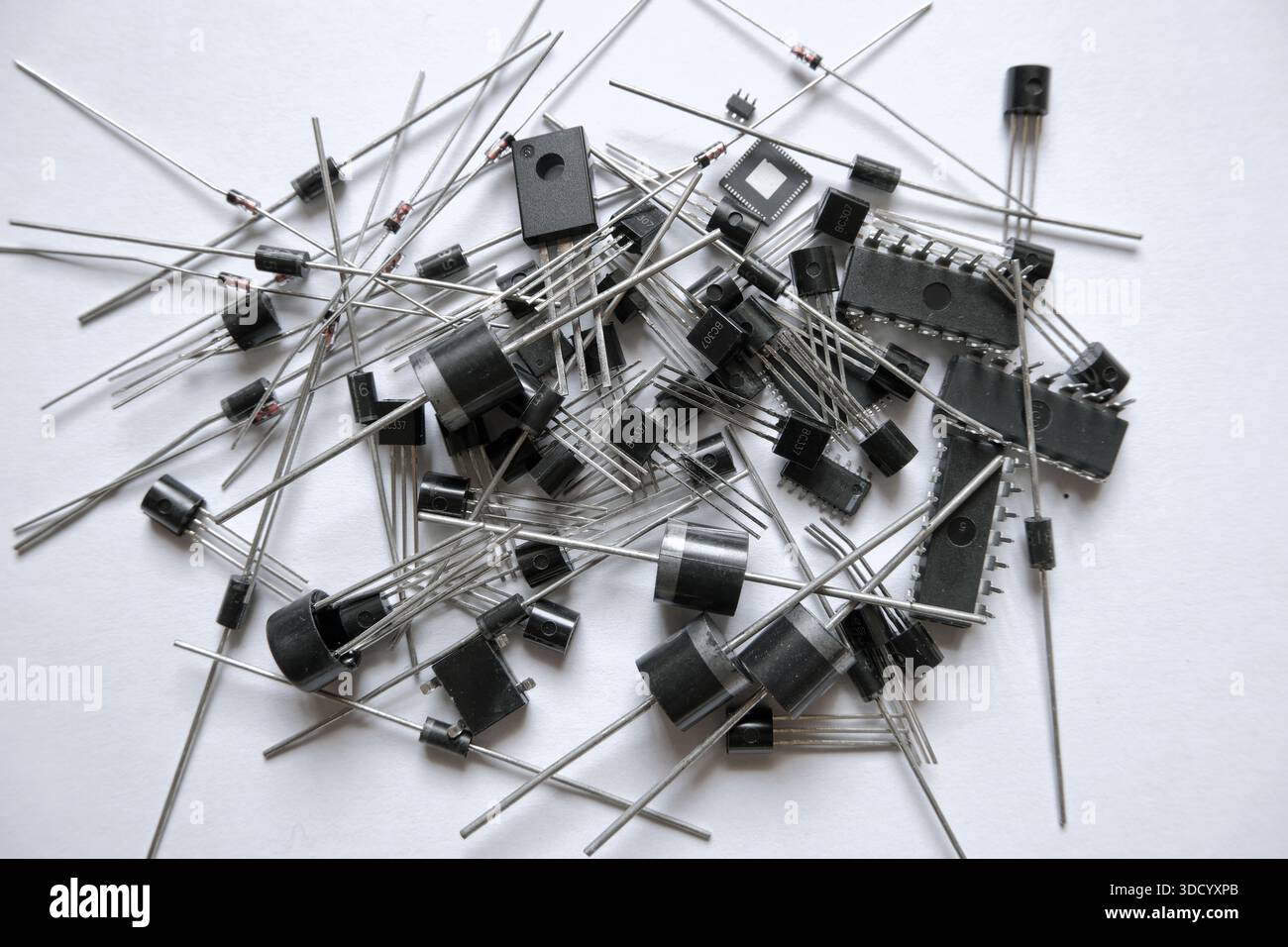 Heap of semiconductor electronic components. Diodes, integrated circuits, transistors, microchips. Stock Photo