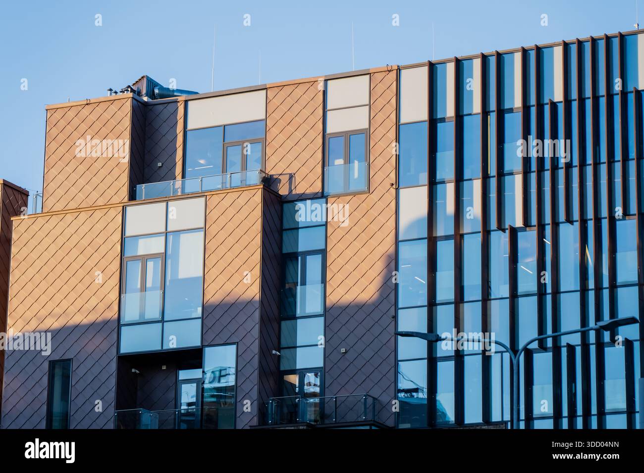 Modern commercial building facade with glass windows and patterned ...