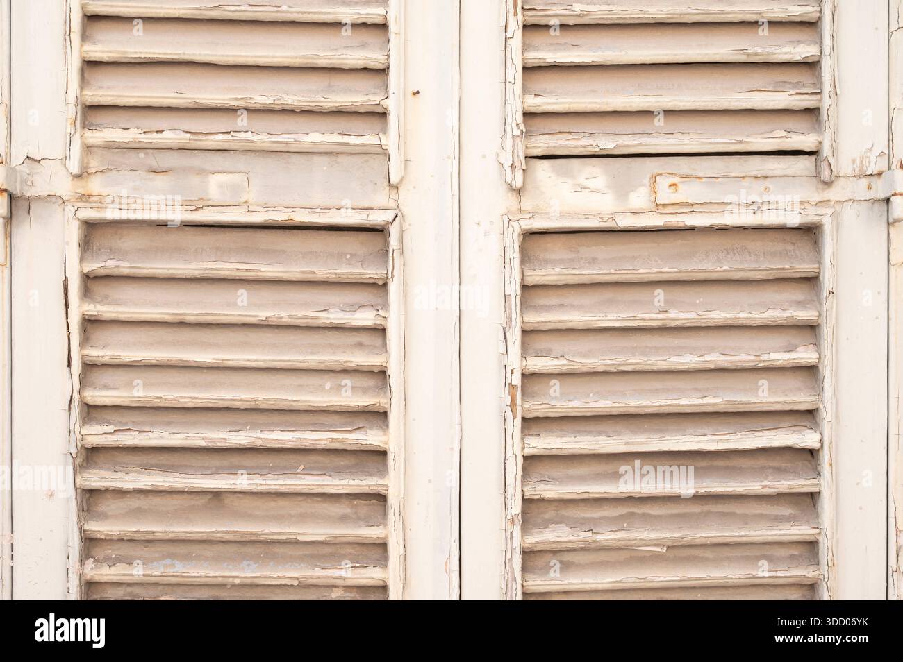 Weathered wooden window shutters with dirty ochre peeling paint ...