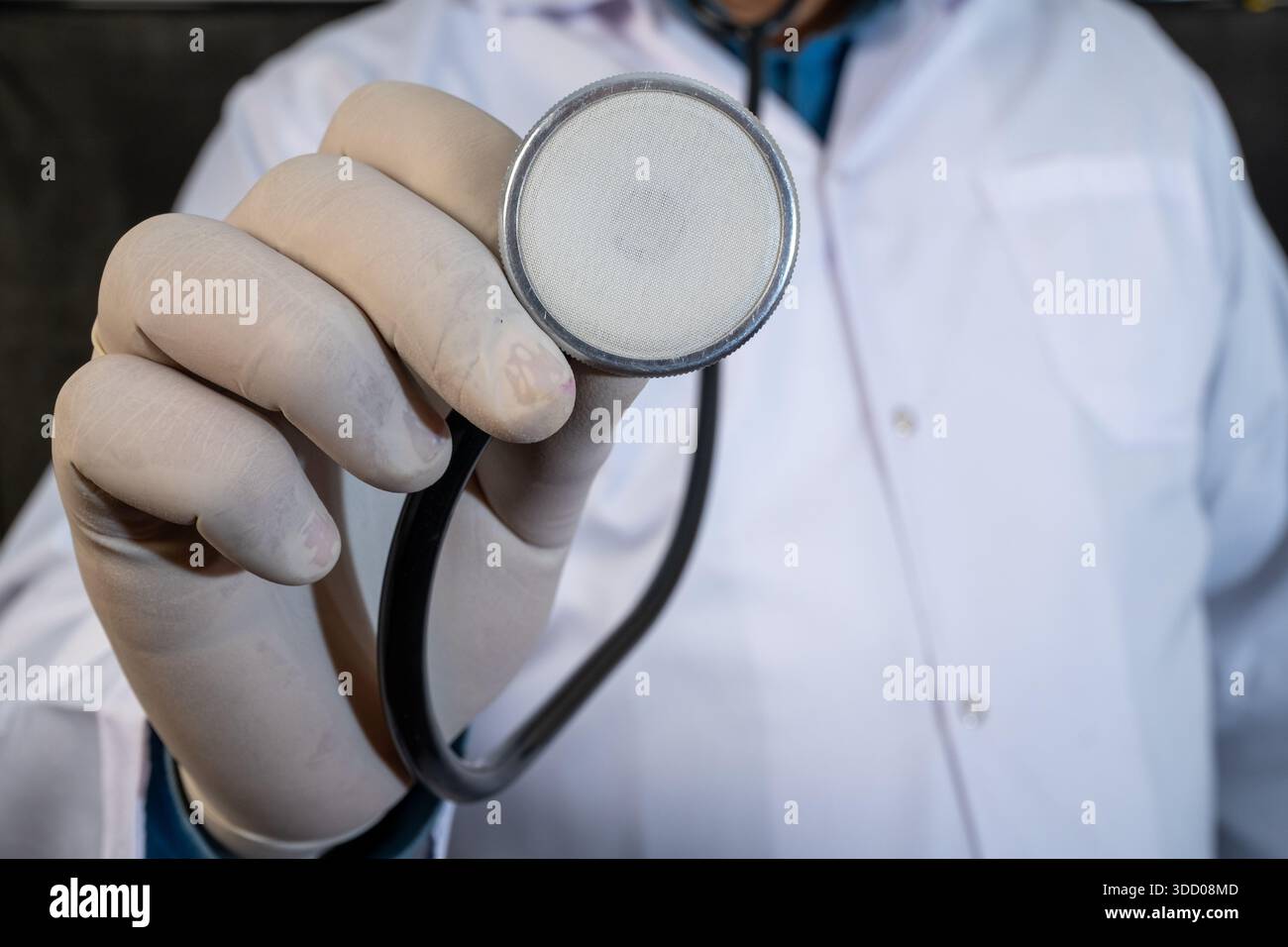 Medical professional holding a stethoscope toward camera for heart examination Stock Photo