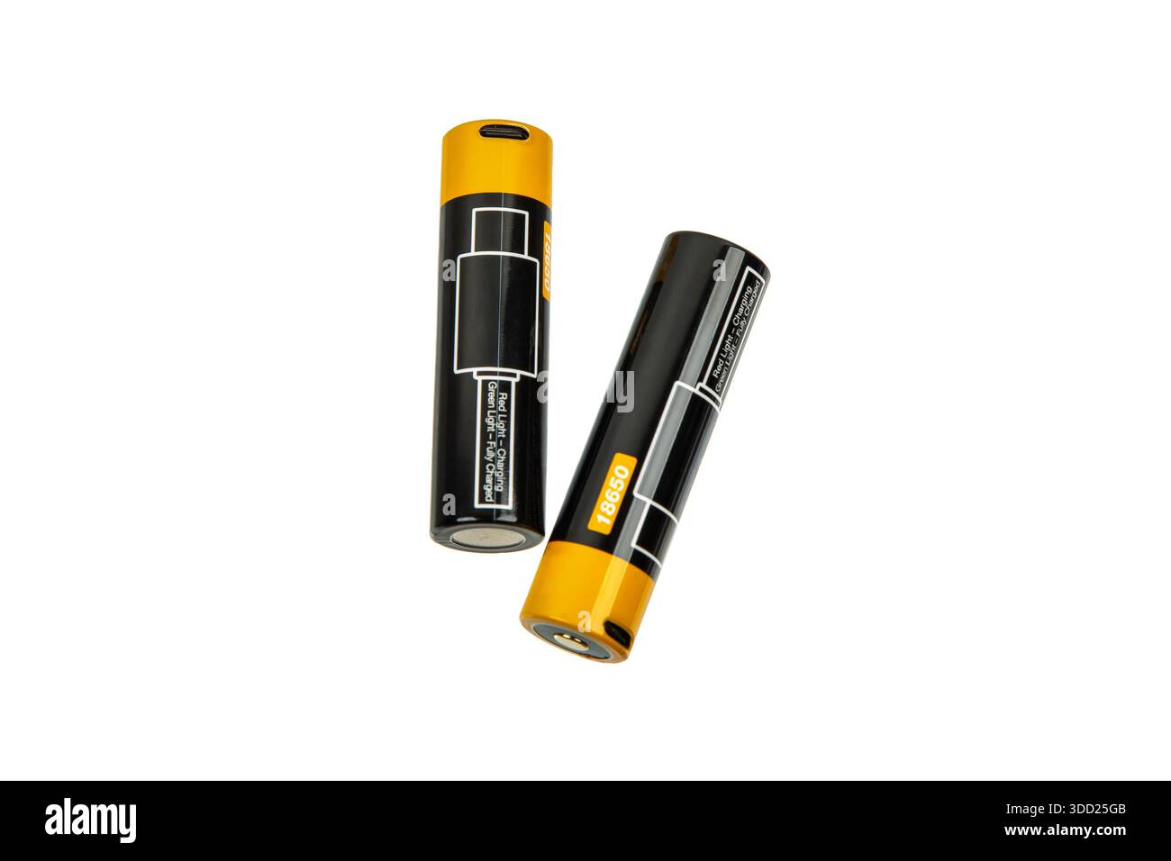 Two 18650 lithium-ion rechargeable batteries with built-in micro-USB charging ports and LED status indicators, isolated on a white background. Stock Photo