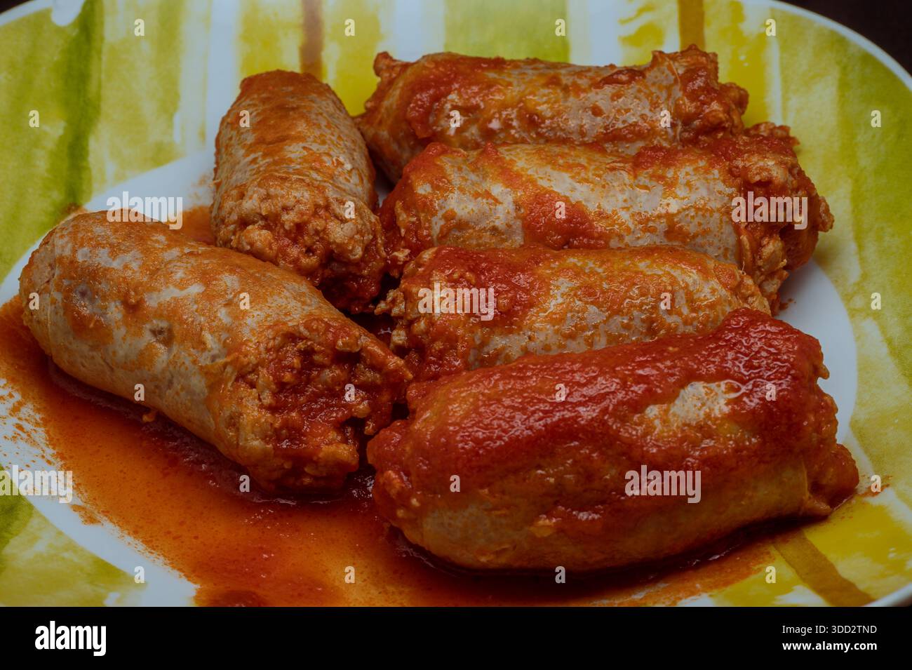 Pork sausages in tomato sauce are a succulent and tasty dish, very easy to prepare. Stock Photo