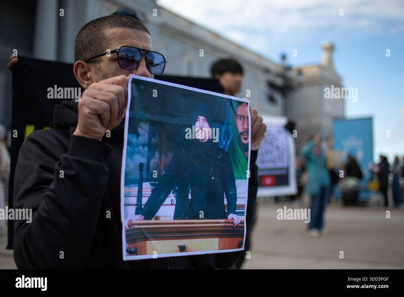 A Man Carries A Photograph Of The Religious Leader Abdullah Hashem a-man-carries-a-photograph-of-the-religious-leader-abdullah-hashem