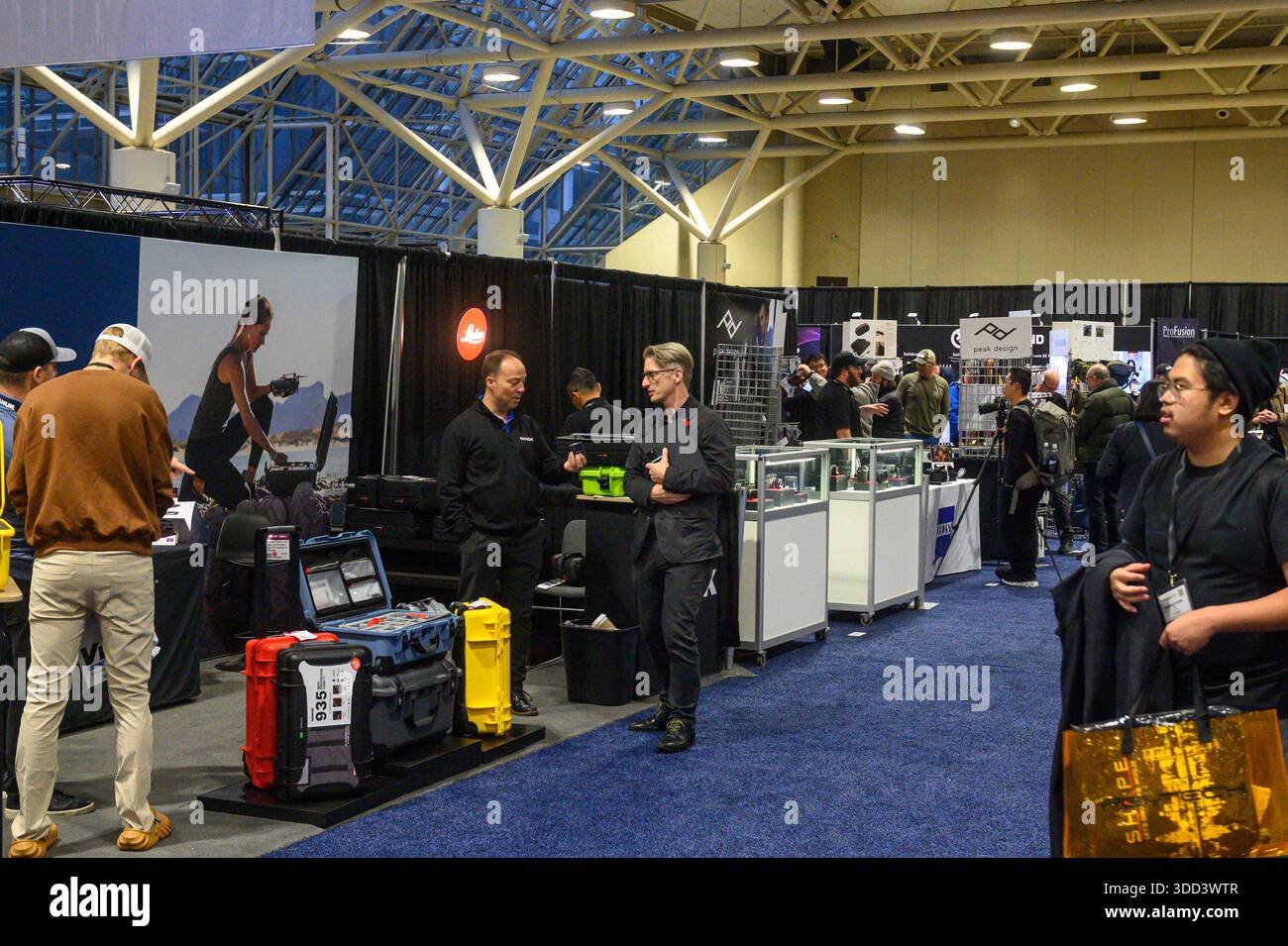 Toronto, ON, Canada - November 6, 2025: Trade show attendees explore vendor booths and product displays, networking and discovering technology and equ Stock Photo