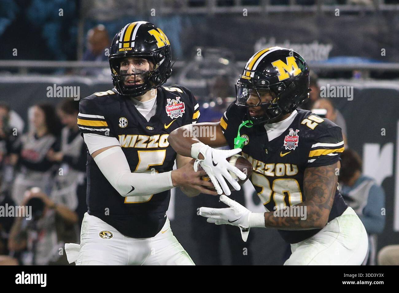Missouri quarterback Matt Zollers, left, handsoff the ball to running