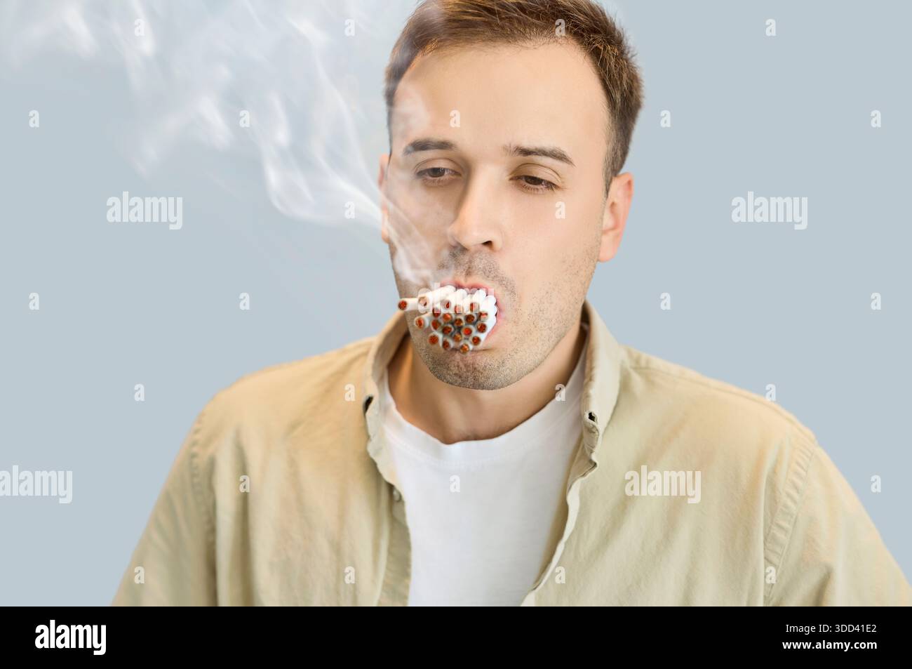 multiple cigarette smoker Man smokes multiple cigarettes, illustrating nicotine dependence and health  risk Stock Photo