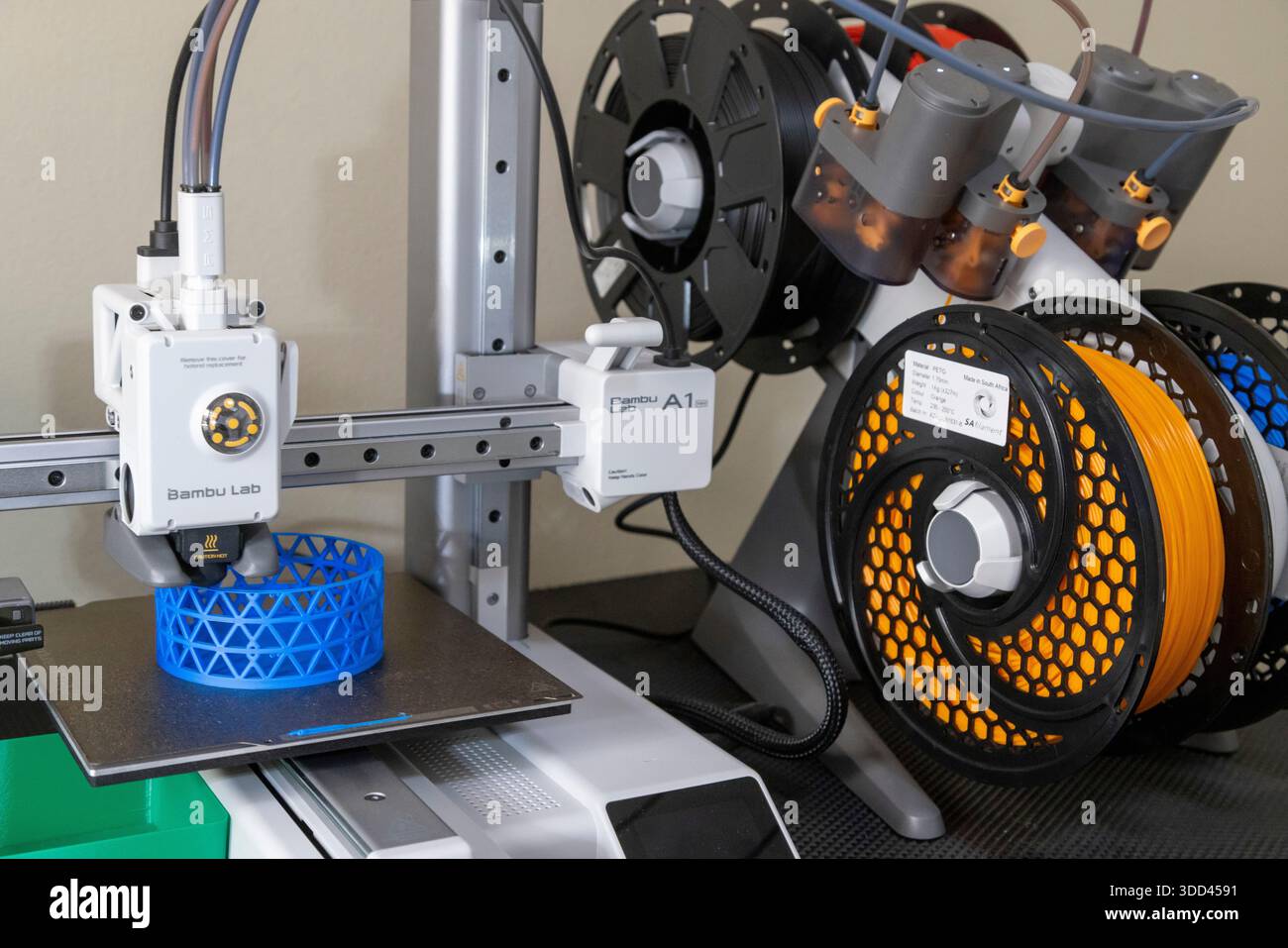 A close-up of a Bambu Lab 3D printer crafting a blue lattice cylinder. The  printer head and emerging structure are sharply focused, ideal for illustra  Stock Photo - Alamy