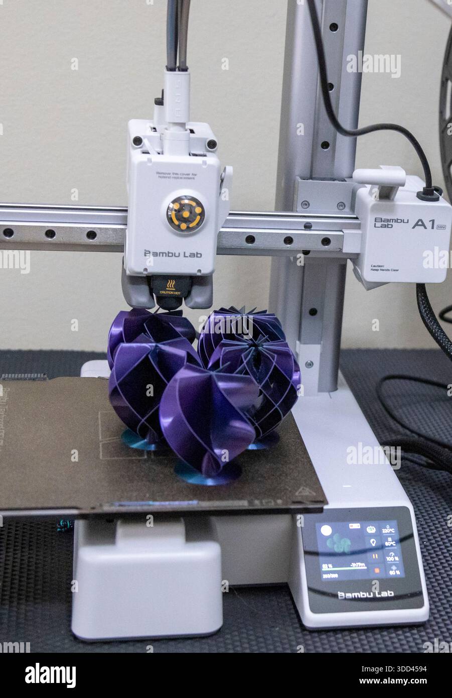 Five complex shaped Christmas decorations during printing on a Bambu Lab 3D printer Stock Photo