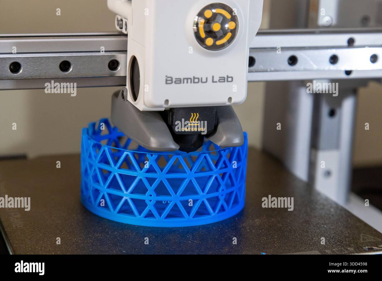 A close-up of a Bambu Lab 3D printer crafting a blue lattice cylinder. The  printer head and emerging structure are sharply focused, ideal for illustra  Stock Photo - Alamy